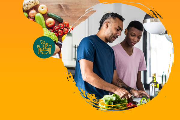 Pai e filho negros preparam alimentos